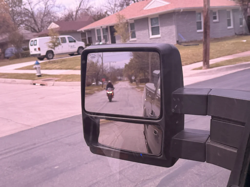 Motorcycle visible in driver's side rearview mirror on Belt Line Road Addison TX 75001 &mdash; key evidence photograph from a Dallas County criminal defense investigation by Terrance PI