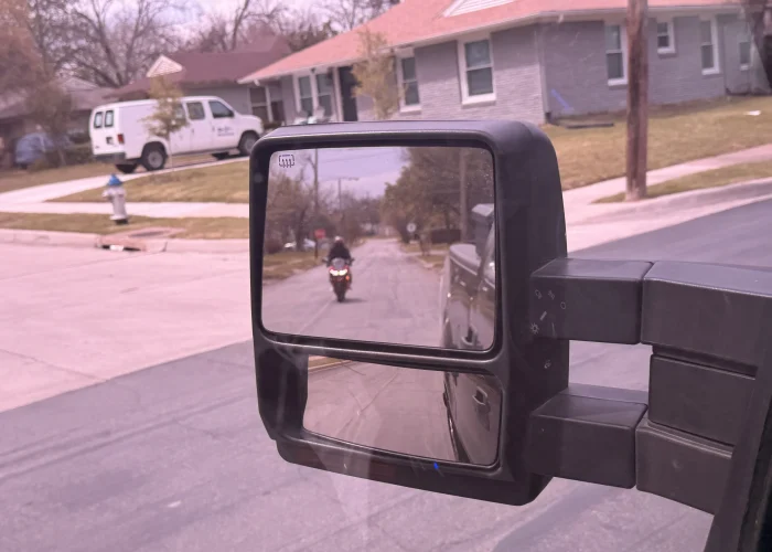 Motorcycle visible in driver's side rearview mirror on Belt Line Road Addison TX 75001 — key evidence photograph from a Dallas County criminal defense investigation by Terrance PI