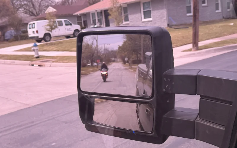 Motorcycle visible in driver's side rearview mirror on Belt Line Road Addison TX 75001 — key evidence photograph from a Dallas County criminal defense investigation by Terrance PI